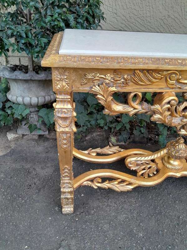 A 20th Century Ornately Carved and Hand-Gilded Console Table with Cream Marble Top