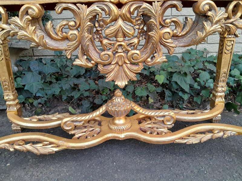 A 20th Century Ornately Carved and Hand-Gilded Console Table with Cream Marble Top