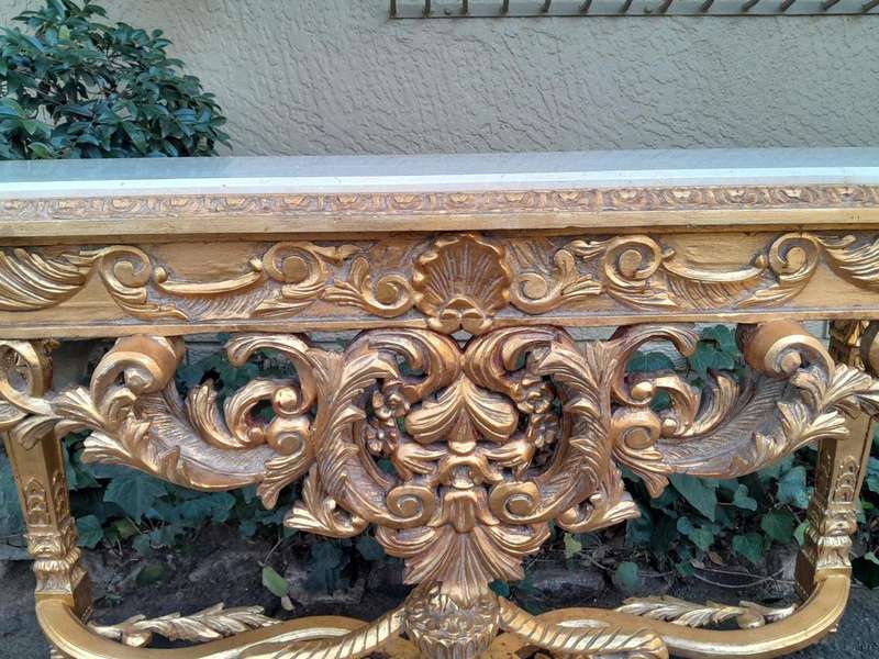 A 20th Century Ornately Carved and Hand-Gilded Console Table with Cream Marble Top