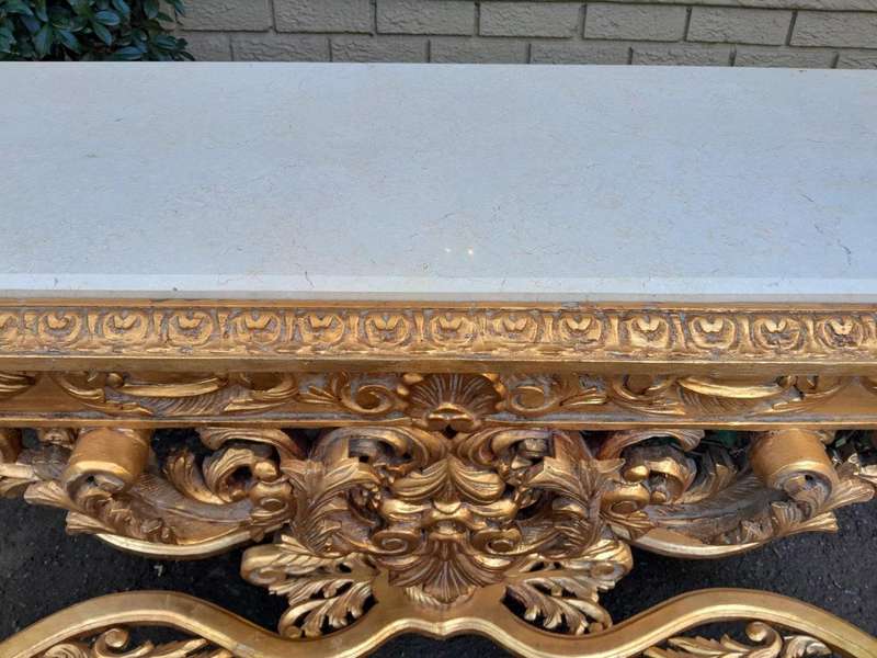A 20th Century Ornately Carved and Hand-Gilded Console Table with Cream Marble Top