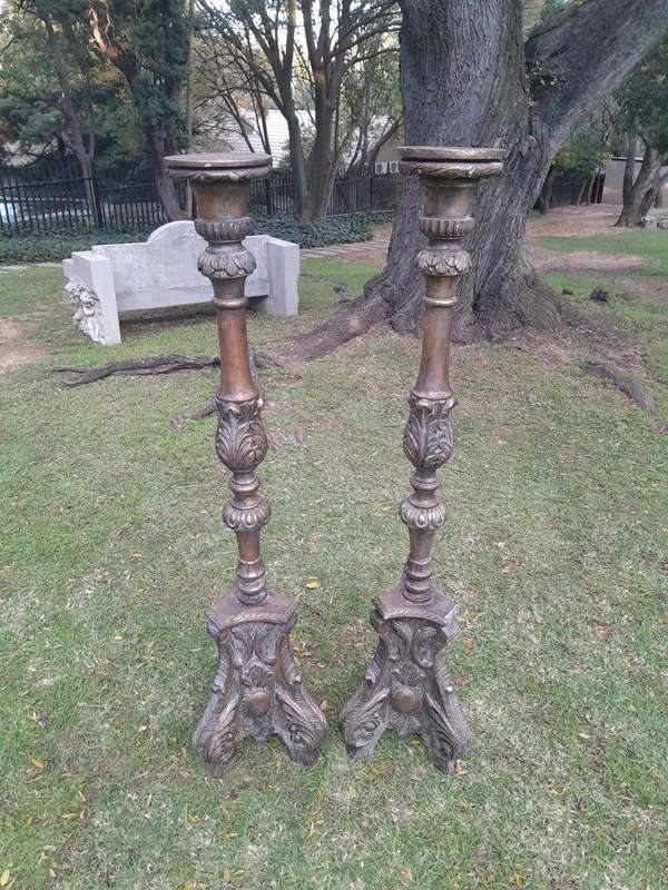 A Pair of French Style Carved and Gilded Floor or Table Candle Holders