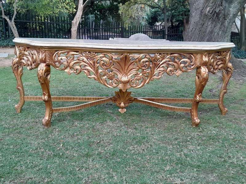 A 20th Century Ornately Carved and Hand-Gilded Console Table of Large Proportion with Cream Marbl...
