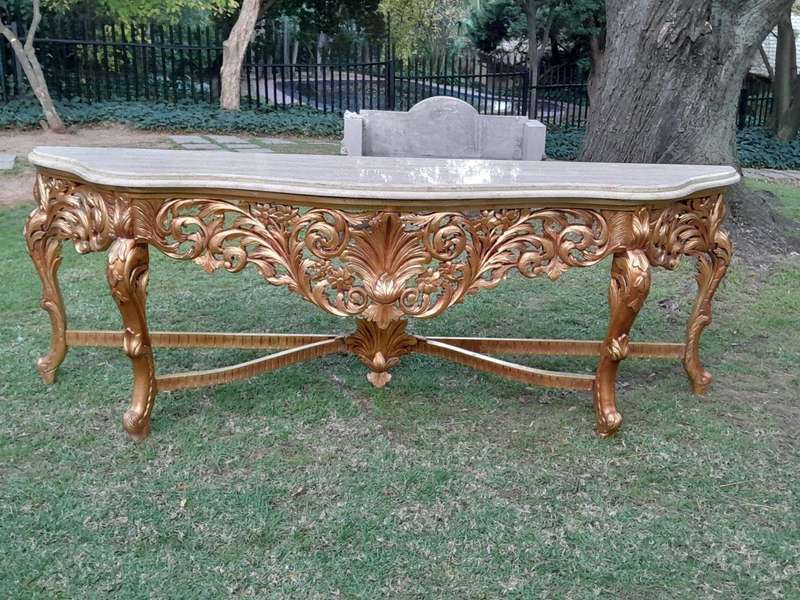 A 20th Century Ornately Carved and Hand-Gilded Console Table of Large Proportion with Cream Marbl...