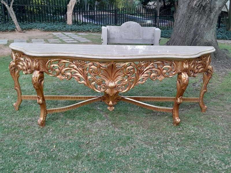 A 20th Century Ornately Carved and Hand-Gilded Console Table of Large Proportion with Cream Marbl...