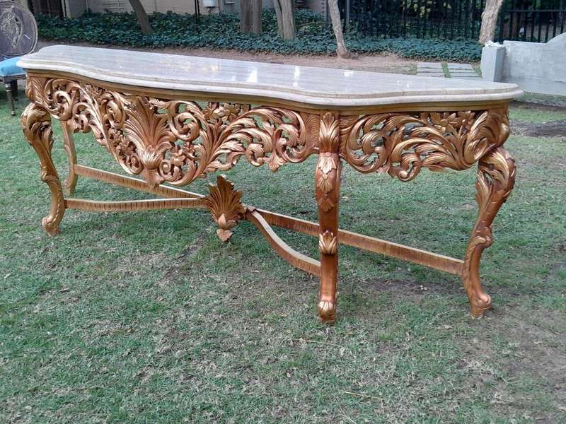 A 20th Century Ornately Carved and Hand-Gilded Console Table of Large Proportion with Cream Marbl...