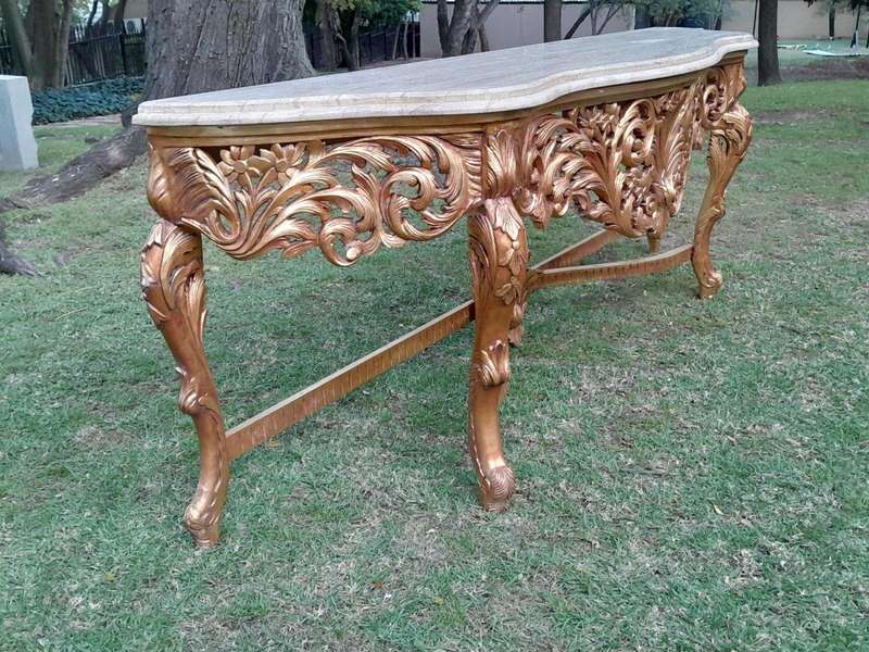 A 20th Century Ornately Carved and Hand-Gilded Console Table of Large Proportion with Cream Marbl...