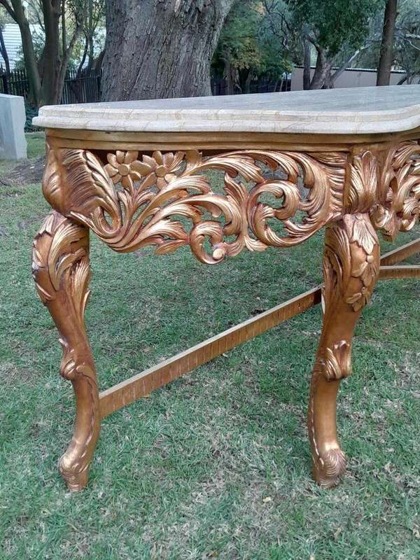 A 20th Century Ornately Carved and Hand-Gilded Console Table of Large Proportion with Cream Marbl...