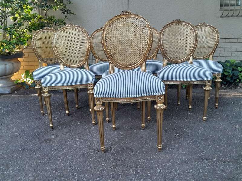 A Set of Eight French Style Carved Balloon and Rattan Back Chairs Upholstered in a Contemporary F...