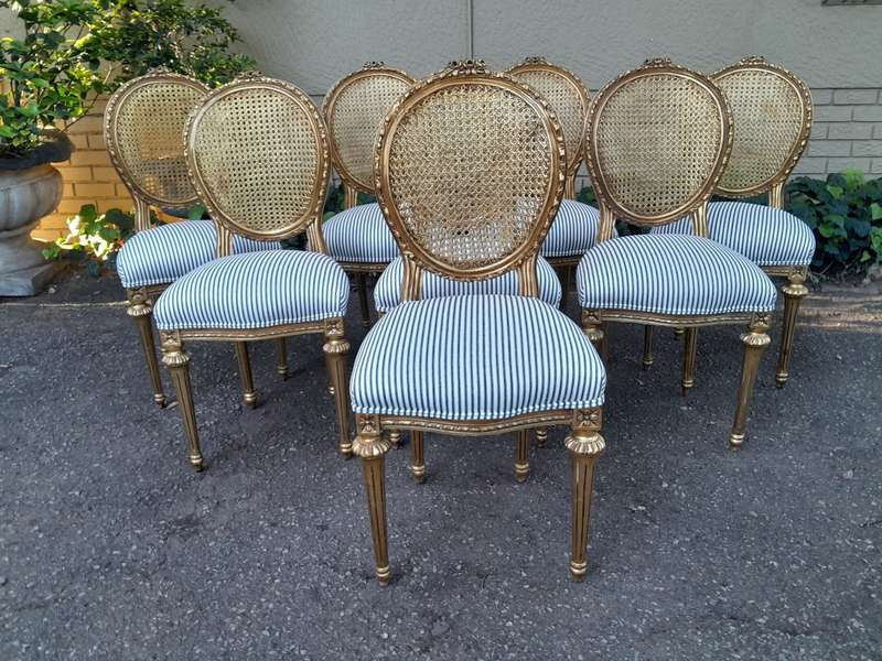 A Set of Eight French Style Carved Balloon and Rattan Back Chairs Upholstered in a Contemporary F...