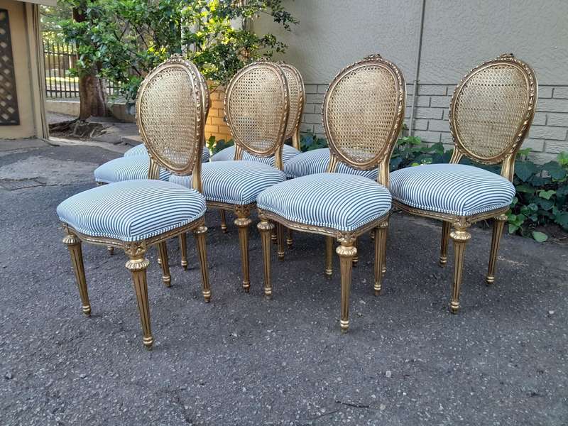 A Set of Eight French Style Carved Balloon and Rattan Back Chairs Upholstered in a Contemporary F...