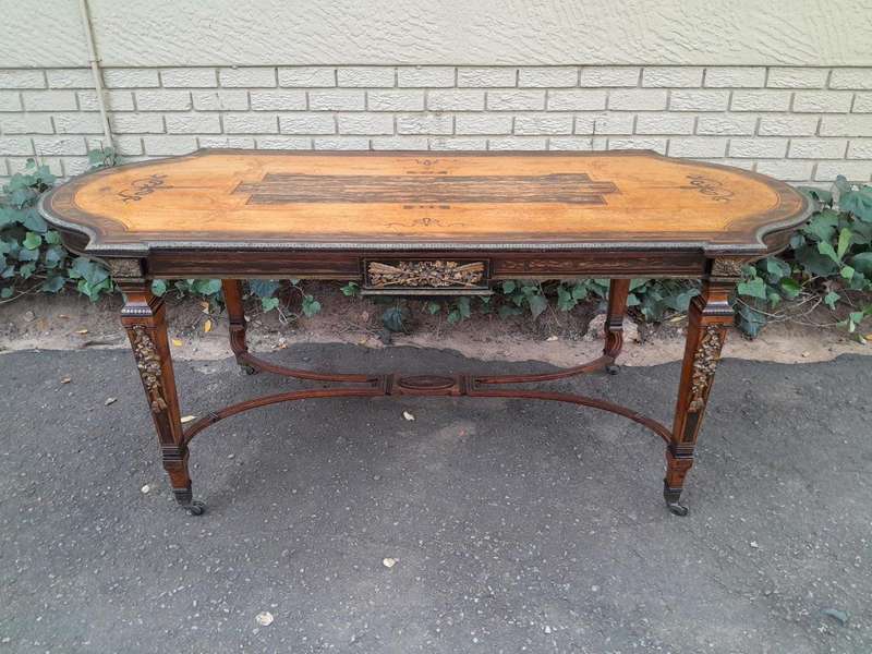 A Napoleon Marquetry Table On Castors