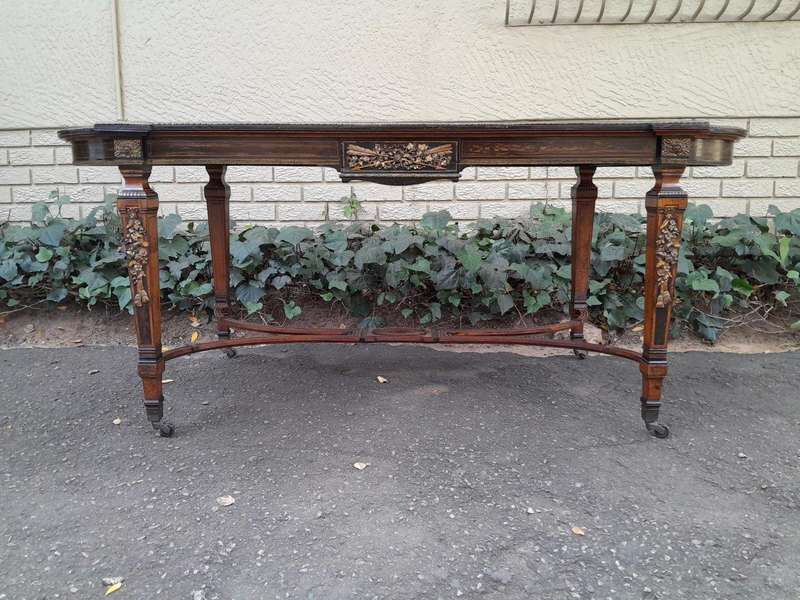 A Napoleon Marquetry Table On Castors