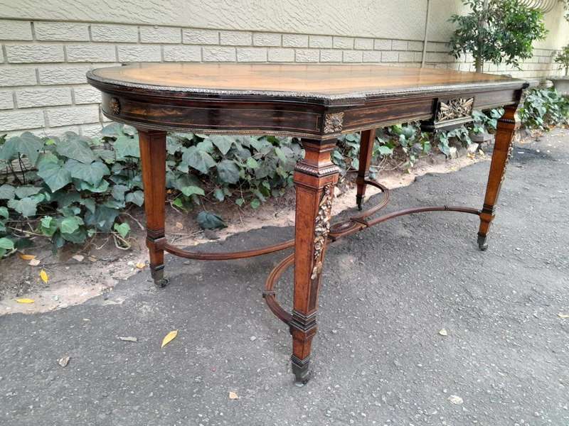 A Napoleon Marquetry Table On Castors