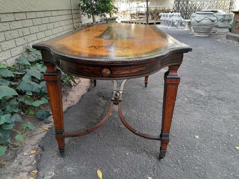 A Napoleon Marquetry Table On Castors