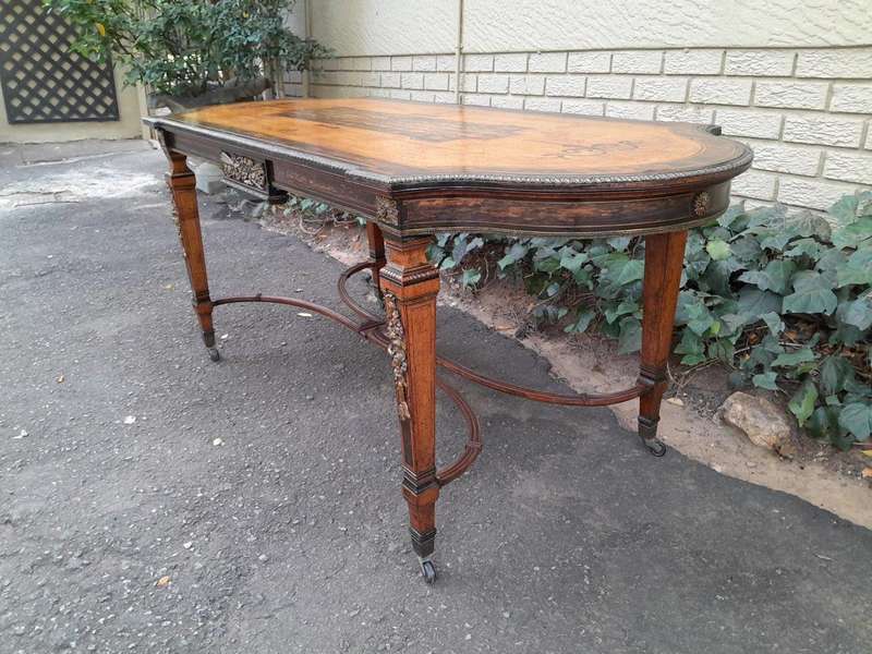 A Napoleon Marquetry Table On Castors