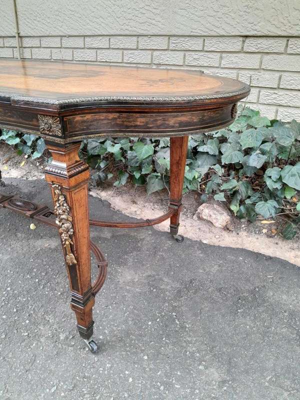 A Napoleon Marquetry Table On Castors