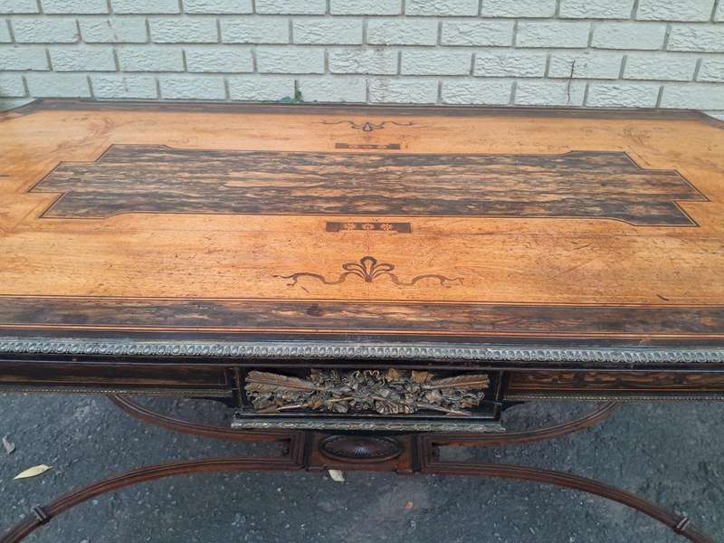 A Napoleon Marquetry Table On Castors