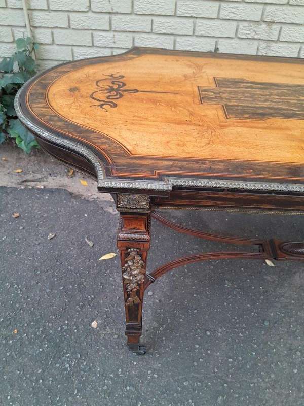 A Napoleon Marquetry Table On Castors