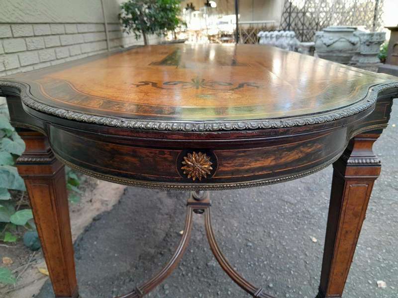 A Napoleon Marquetry Table On Castors