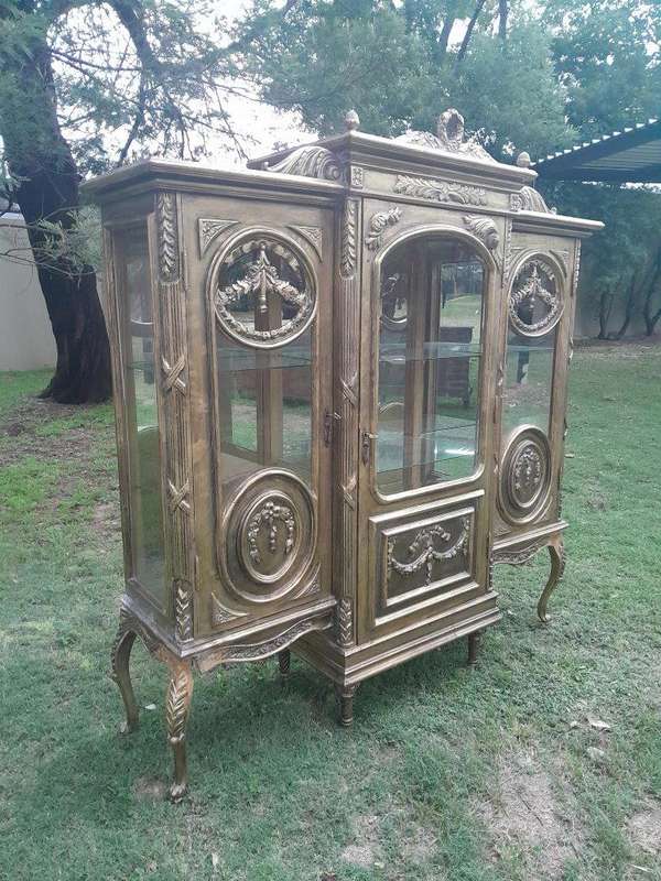 A 20th Century French Style Three Division and Large Ornately Carved and Hand-Gilded Display Cabinet