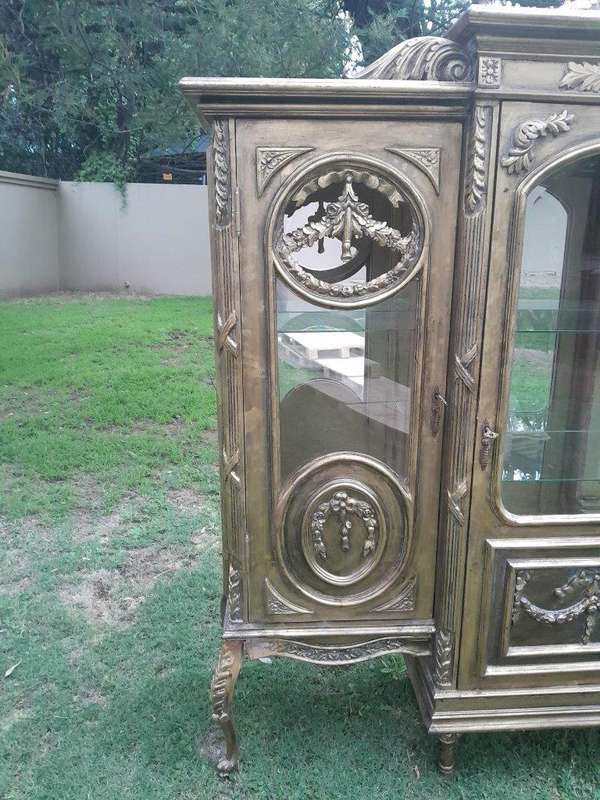 A 20th Century French Style Three Division and Large Ornately Carved and Hand-Gilded Display Cabinet
