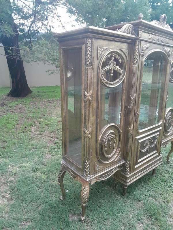 A 20th Century French Style Three Division and Large Ornately Carved and Hand-Gilded Display Cabinet