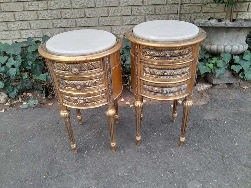 A Pair Of French Style Hand-Gilded Round Pedestals / Side Tables With Drawers And Cream Marble Tops