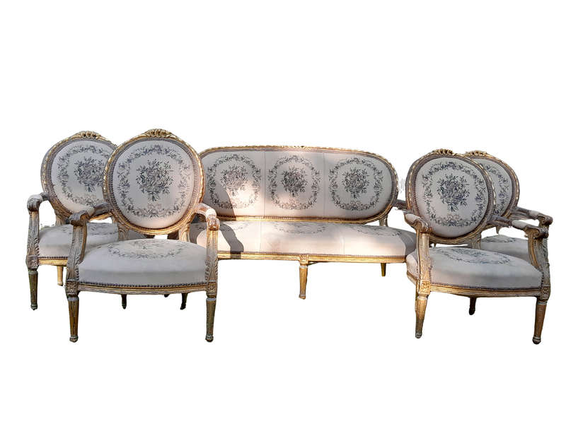 A 20th Century French Louis XVI Style Set of a Carved and Gilded Settee and Four Armchairs with T...