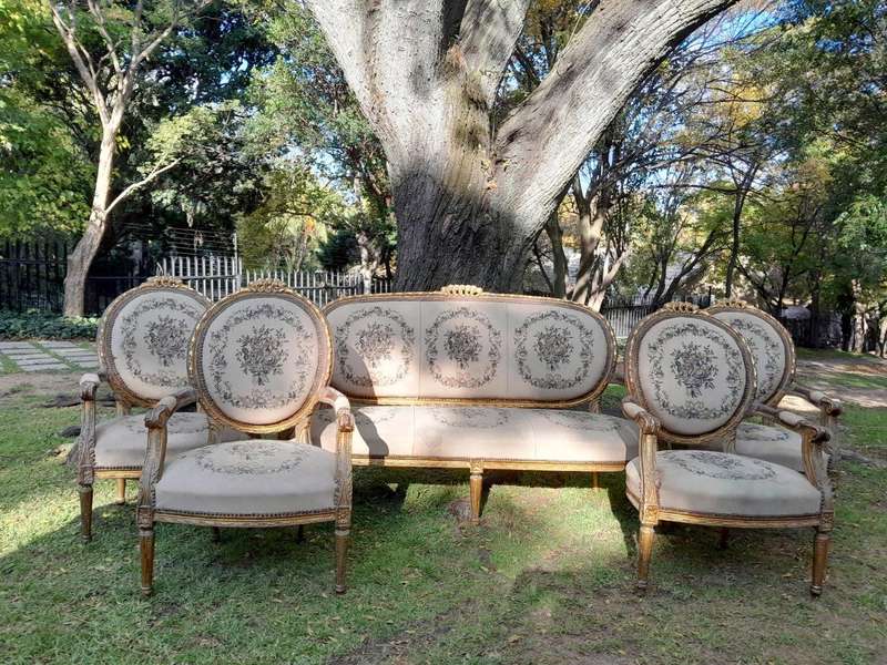 A 20th Century French Louis XVI Style Set of a Carved and Gilded Settee and Four Armchairs with T...