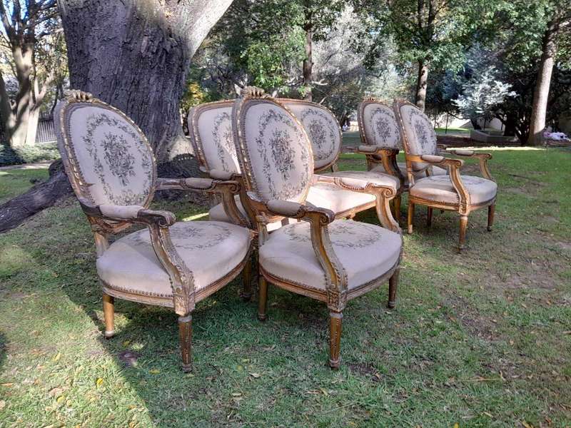 A 20th Century French Louis XVI Style Set of a Carved and Gilded Settee and Four Armchairs with T...