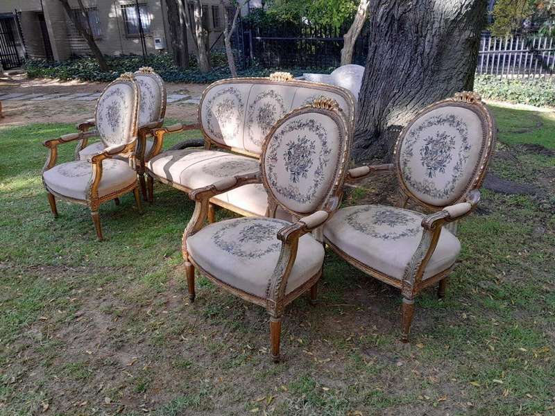 A 20th Century French Louis XVI Style Set of a Carved and Gilded Settee and Four Armchairs with T...