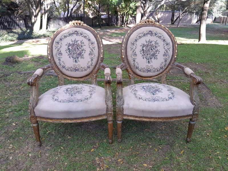 A 20th Century French Louis XVI Style Set of a Carved and Gilded Settee and Four Armchairs with T...