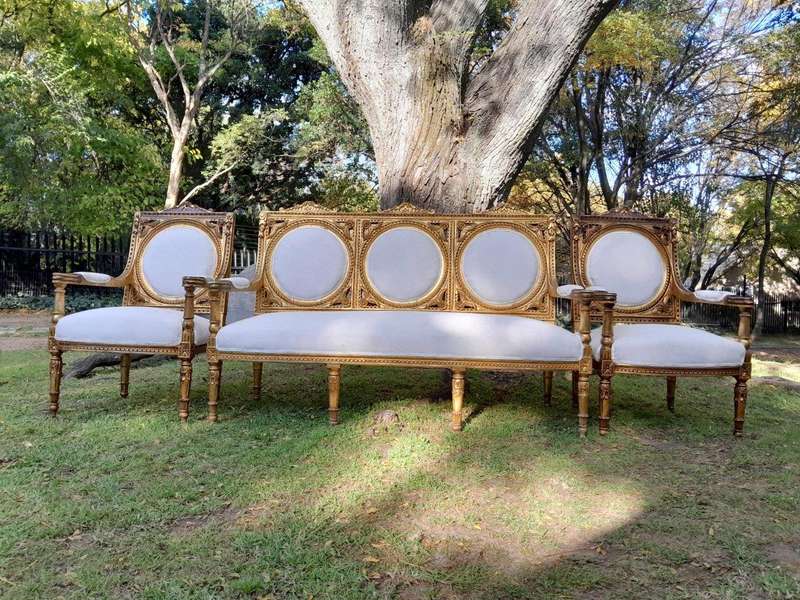 A 20th Century French Style Ornately Carved Gilt Wood Set Comprising a Settee and Pair of Armchairs