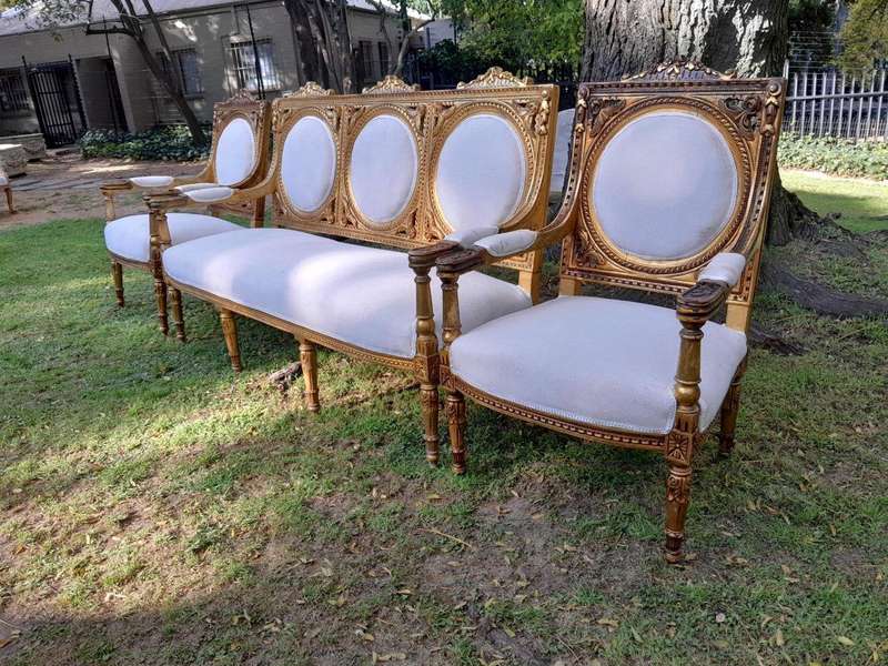 A 20th Century French Style Ornately Carved Gilt Wood Set Comprising a Settee and Pair of Armchairs