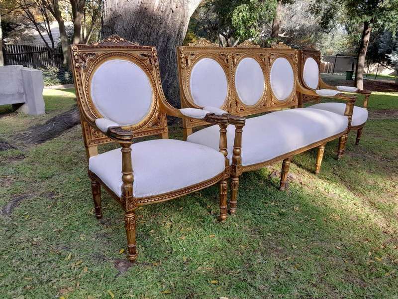 A 20th Century French Style Ornately Carved Gilt Wood Set Comprising a Settee and Pair of Armchairs