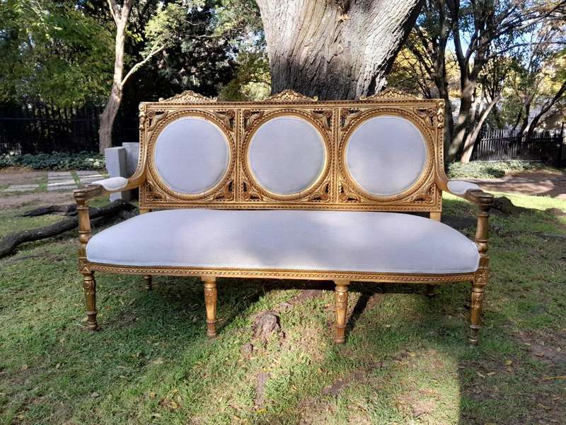 A 20th Century French Style Ornately Carved Gilt Wood Set Comprising a Settee and Pair of Armchairs