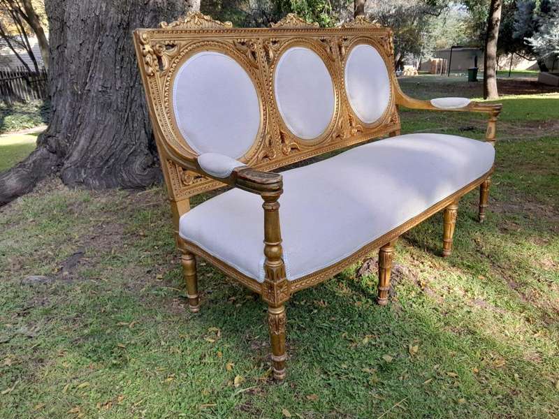 A 20th Century French Style Ornately Carved Gilt Wood Set Comprising a Settee and Pair of Armchairs