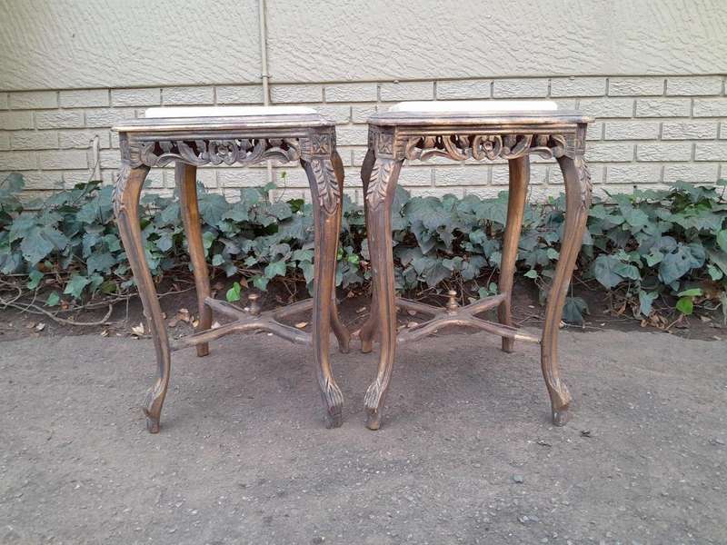 A 20TH Century French Style Pair Of Carved And Gilded Side Tables With Marble Tops