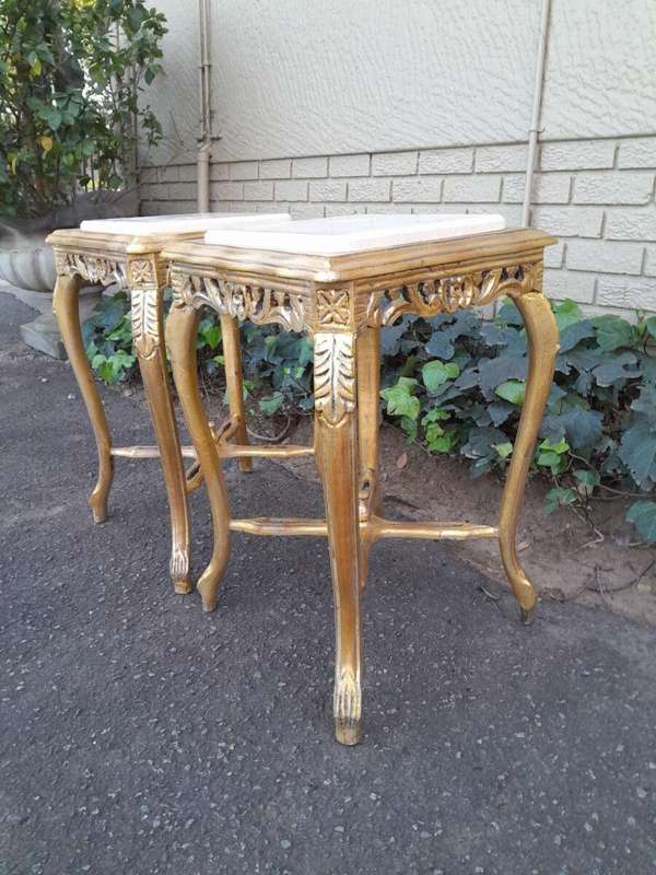A 20TH Century French Style Pair Of Carved And Gilded Side Tables With Marble Tops