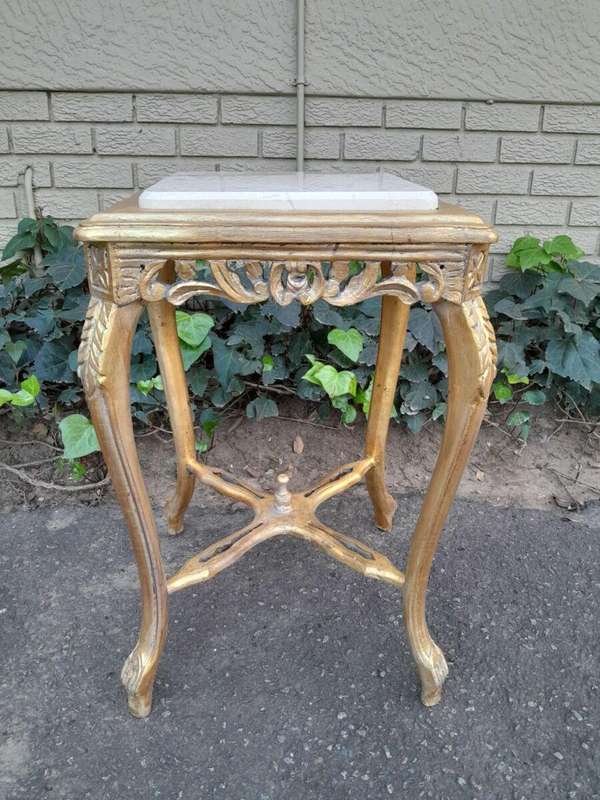 A 20TH Century French Style Pair Of Carved And Gilded Side Tables With Marble Tops
