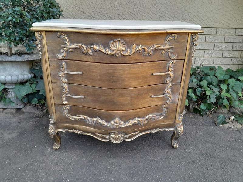 A French Style Ornate and Gilded Chest of Drawers with Marble Top