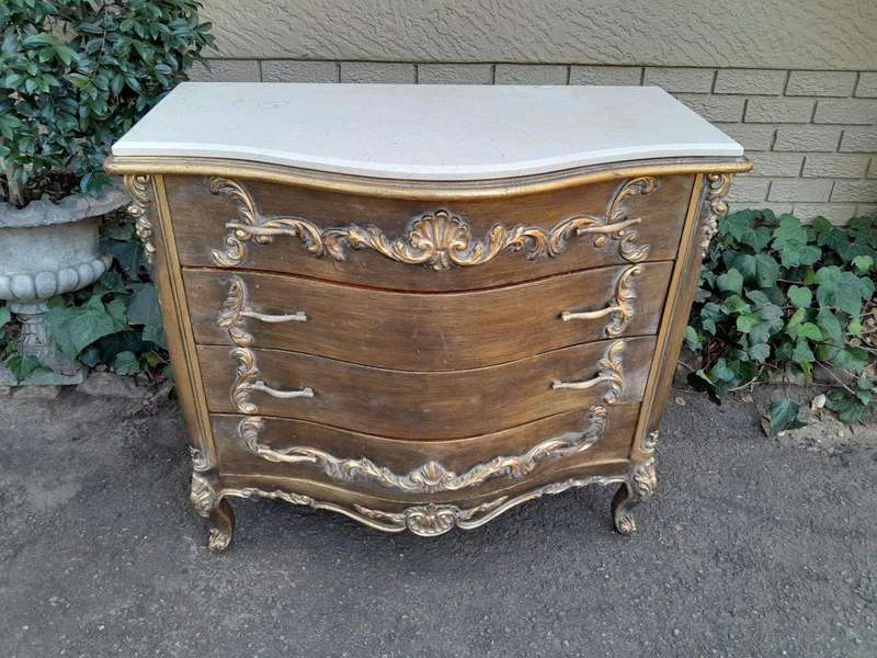 A French Style Ornate and Gilded Chest of Drawers with Marble Top