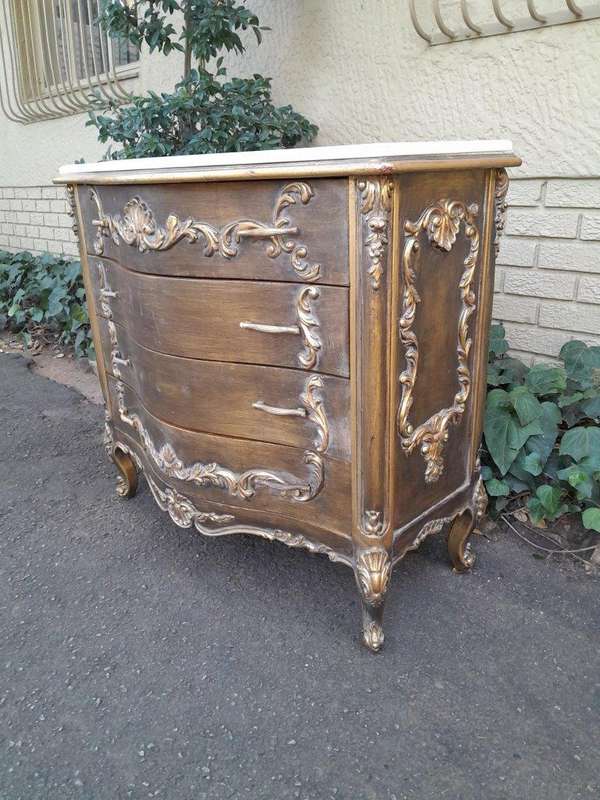 A French Style Ornate and Gilded Chest of Drawers with Marble Top
