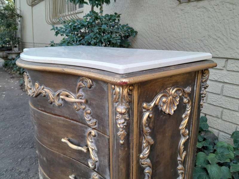 A French Style Ornate and Gilded Chest of Drawers with Marble Top