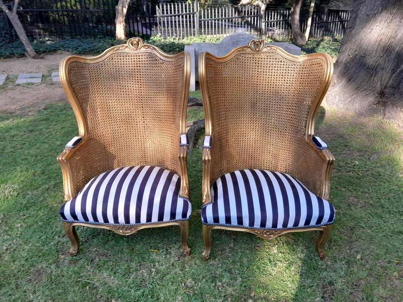 A Pair of 20th Century French Style Gilt Wood Arm Chairs with Rattan Back