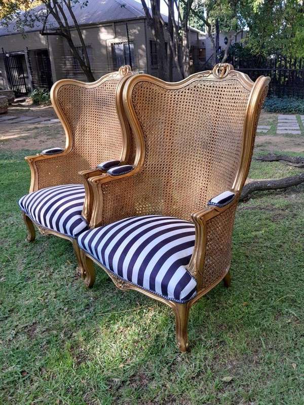 A Pair of 20th Century French Style Gilt Wood Arm Chairs with Rattan Back