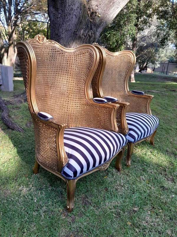A Pair of 20th Century French Style Gilt Wood Arm Chairs with Rattan Back