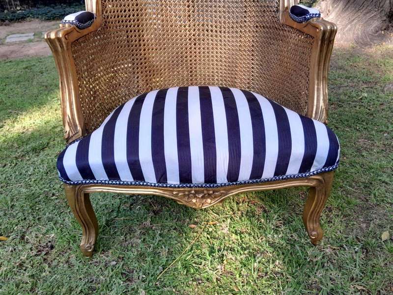 A Pair of 20th Century French Style Gilt Wood Arm Chairs with Rattan Back