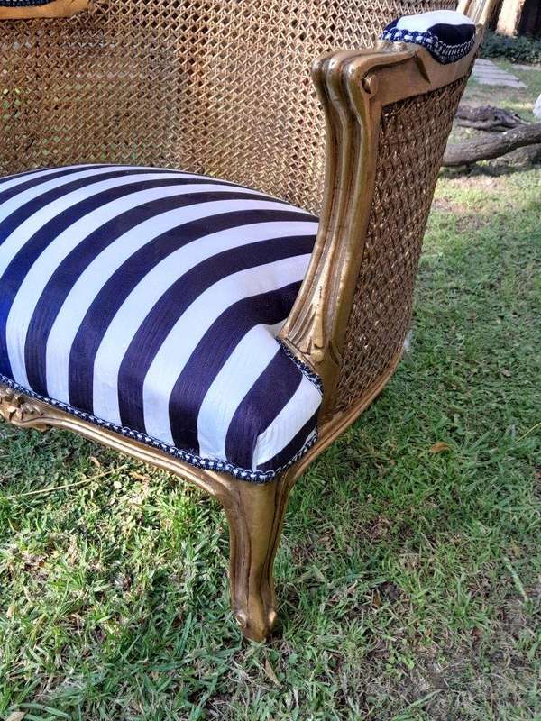 A Pair of 20th Century French Style Gilt Wood Arm Chairs with Rattan Back