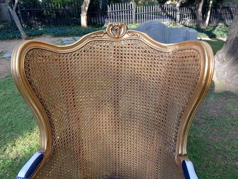 A Pair of 20th Century French Style Gilt Wood Arm Chairs with Rattan Back